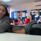 Kid received permission from the teacher to eat a fruit during class.