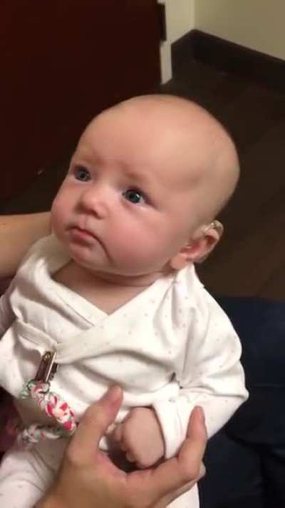 Baby hears mothers voice for the first time with the help of a hearing aid. the reaction is beautiful.