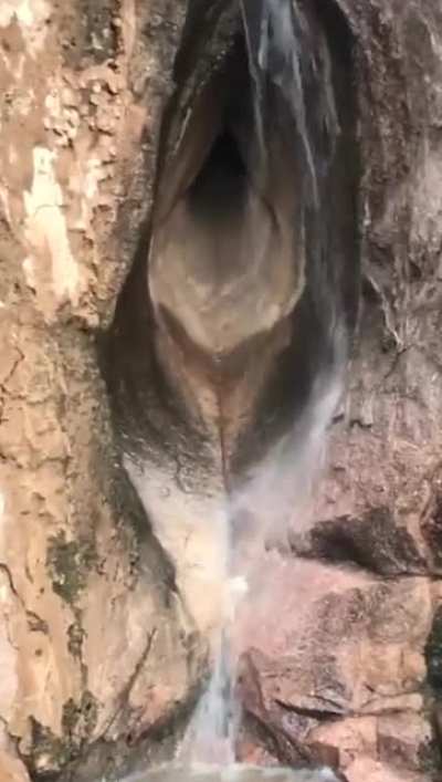 ? Waterfall in a female genital shaped cave