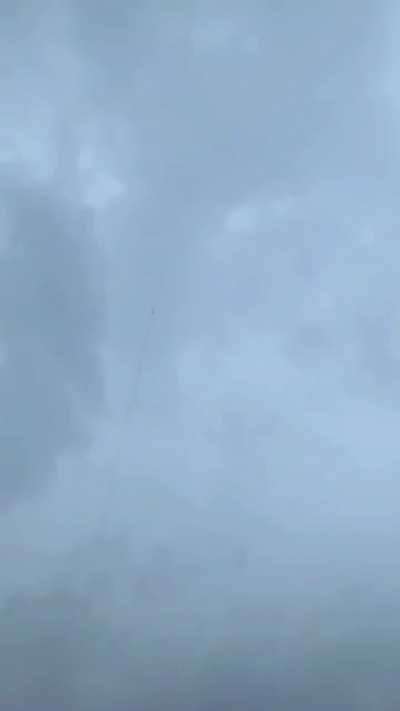 ?Lightning bolt is guided to the ground through the trail of a rocket