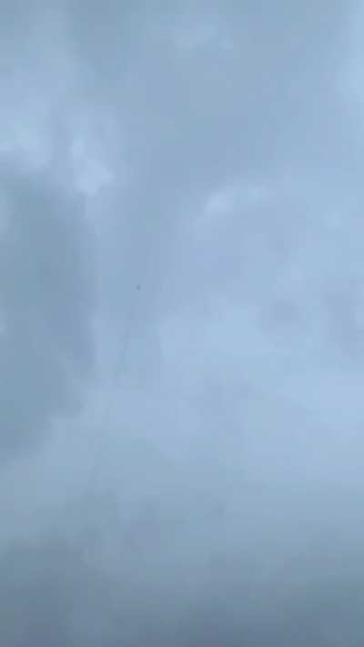 Lightning bolt is guided to ground through rocket trail