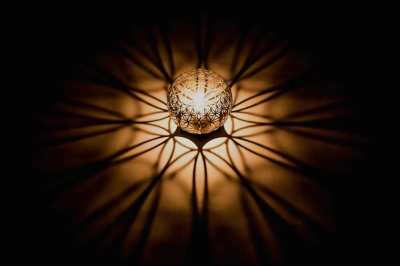 A candle holder which creates a warping geometric projection as it burns