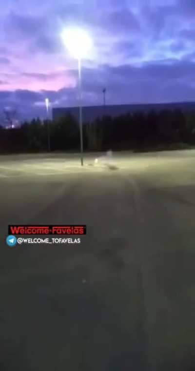 Teenagers blowing up explosive liquid inside bottles in a parking lot
