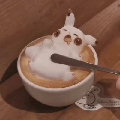 This latte foam art of trying to "wake up" Pikachu