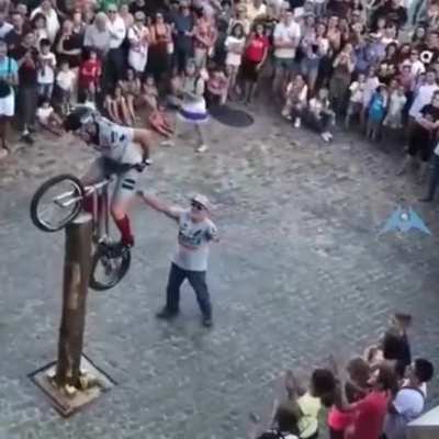 This street trials rider climbing a post