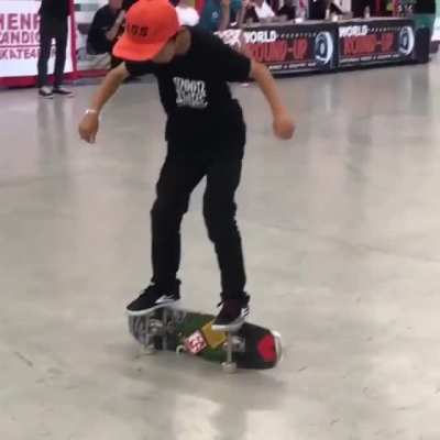 This 9 yr old boy impresses the crowd with his skateboarding skills.