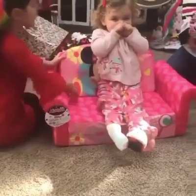 Little girl getting a Minnie Mouse couch