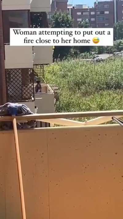 Women attempting to put out a fire close to her home.