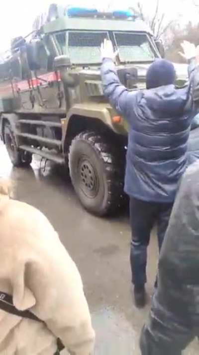 Ukranians in Melitopol trying to stop russian military vehicles, shouting to russians "Invaders, murderers, fascists! Go home! This is not Russia!"