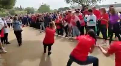 Participating in a women's tug of war competition