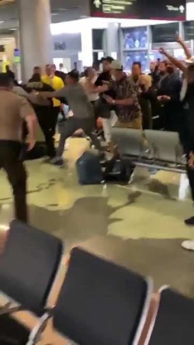Passengers at Miami airport got upset because their flight was cancelled, stole the keys to golf cart, a cop tries to stop them, and he pulls a gun after one of them bites the cop.