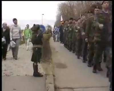 A lone young Belgian boy saluting the Canadians after waiting more than a minute (in source). He is rewarded with an "Eyes right" from the Canadian CO