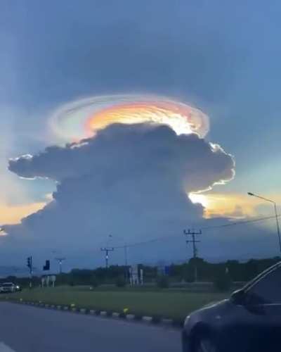 ? What appears to be a Cumulonimbus cloud crowned by a Lenticular Cloud, filmed in Japan.