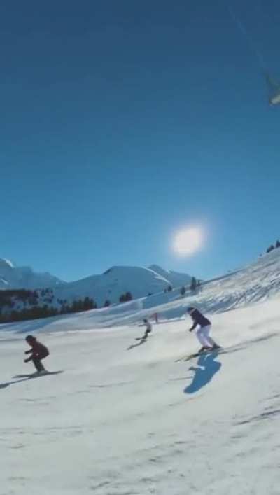 This incredible cameraman films while skiing quickly down a hill