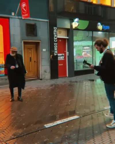 A senior man who really enjoys the music of this street performer
