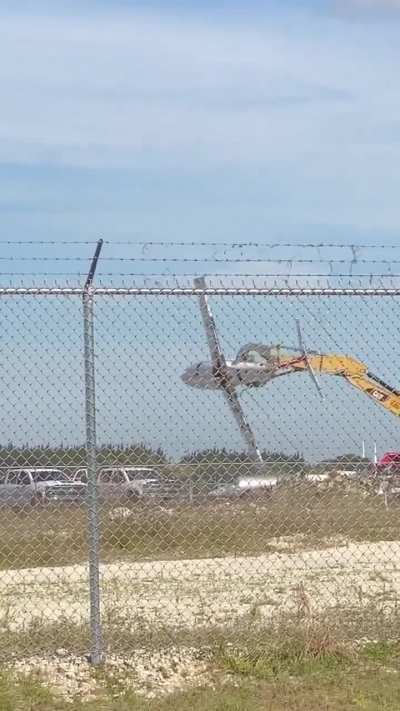 Excavator operator playing with a scrapped plane! ?
