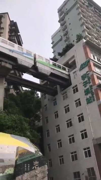 Wait for it... The train passes a 19-story apartment block in Chongqing, China. ?????