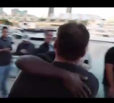 Two Men Wearing "Free Hugs" Shirts Spot Each Other