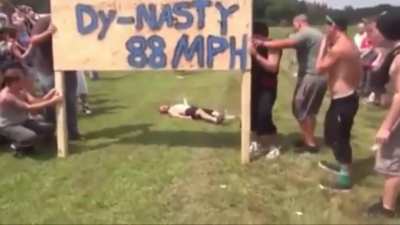Trying to smash through a wood board while riding a bike