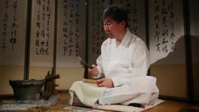 Hot iron for nakjuk (Korean bamboo pyrography) is used to burn poems and patterns onto a sword sheath