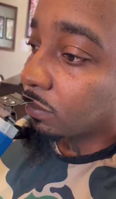 Barber trimming a mustache