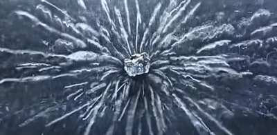 Uranium ore visually emitting alpha particles through supercooled vapour