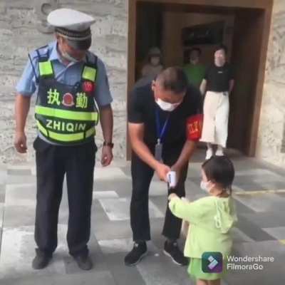 This cute little kid asked the officer. "Sir, could you check our temperature?". That officer is so kind too!