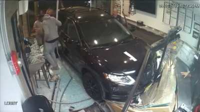 Car crashes into pizza shop