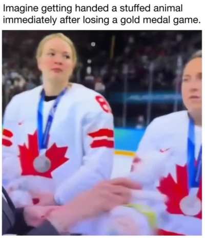 Being handed a stuffed animal after losing in the Olympics