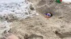 Bury yourself in the sand near the water