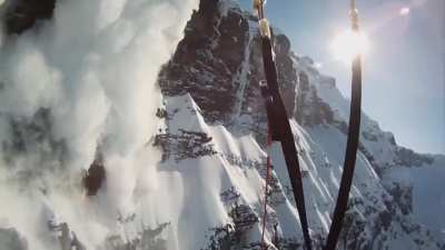 Skier creates an avalanche on purpose, then proceeds to jump off a cliff so he can observe the avalanche from a distance