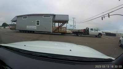 Wide load runs red light, snags overhead wires and blows out transformer.