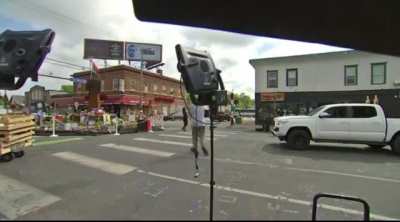 Reporter talks about police reform live in George Floyd Square as gun shots break out.