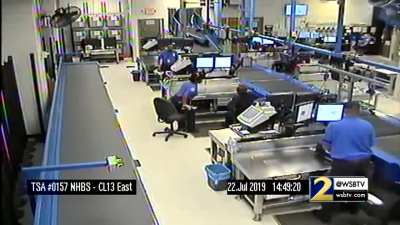 Kid goes for a conveyor belt ride through the baggage-handling area