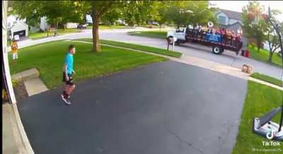 Kid playing basketball in driveway cheered on by the high school band