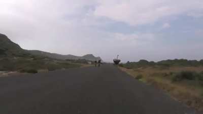 ?Cyclists chased by an Ostrich