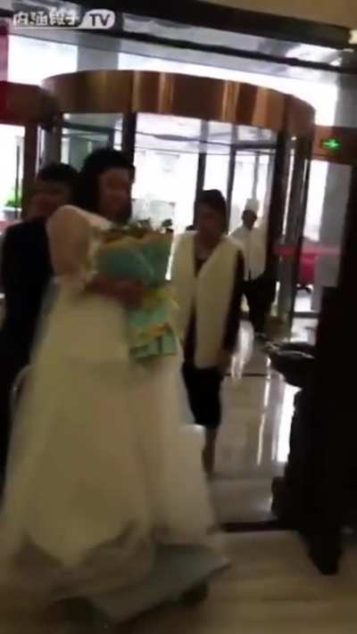 Groom carrying bride....