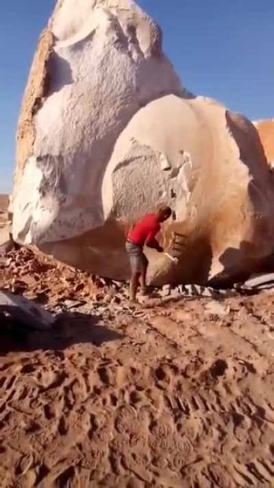 Man splits a giant rock ?