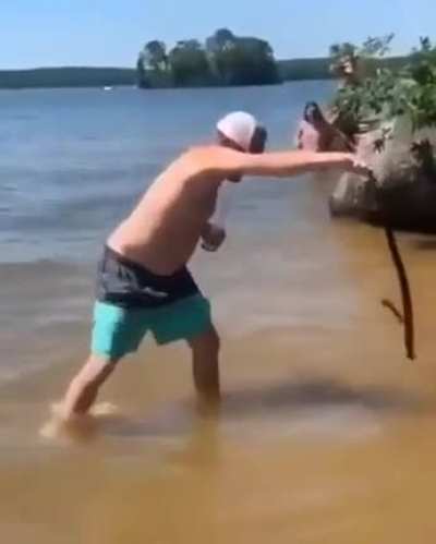 Throwing a snake in a lake.
