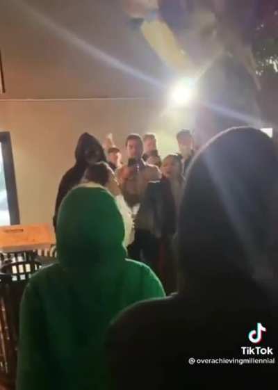 Wearing a KKK robe for Halloween