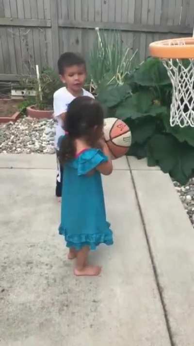 Boy helping his sister