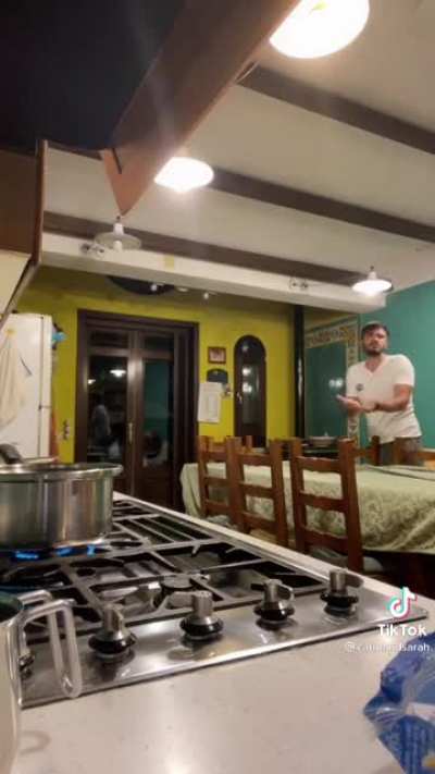 Breaking spaghetti in front of her Fiancé