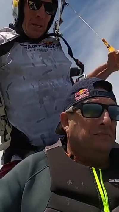 Skydiver safely lands on the backseat of a moving jetski