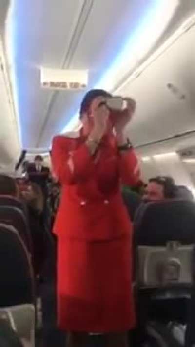 Football fans distract air hostess during safety announcement