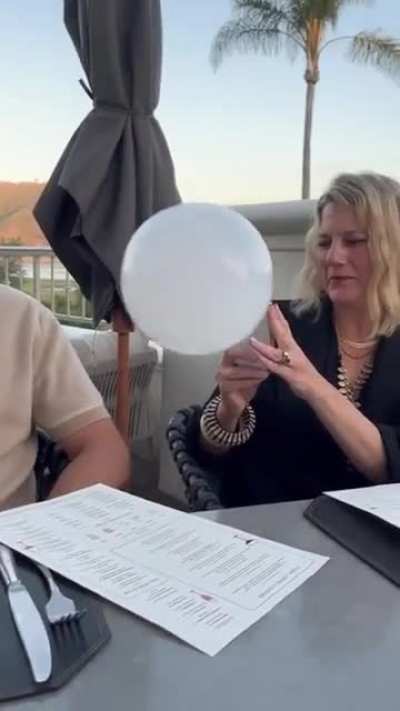 Waiter sends a ball of smoke to a glass of drink