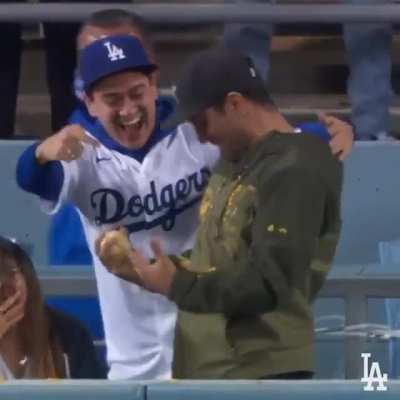 $20 nachos all over this man's jacket can't knock his joy of catching a HR ball