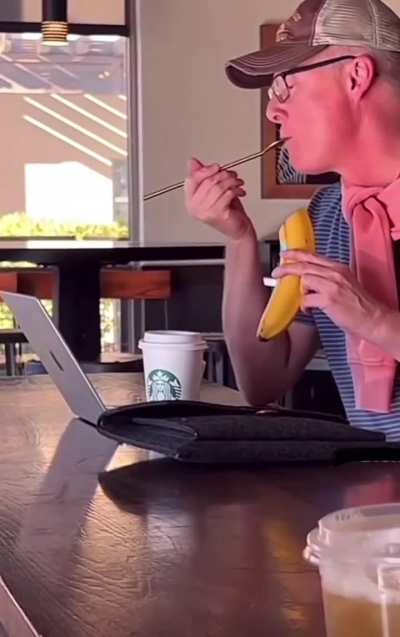 Some guy enjoying a banana