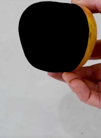 Painting an apple "Musou Black", one of the blackest paints absorbing 99.4% of visible light