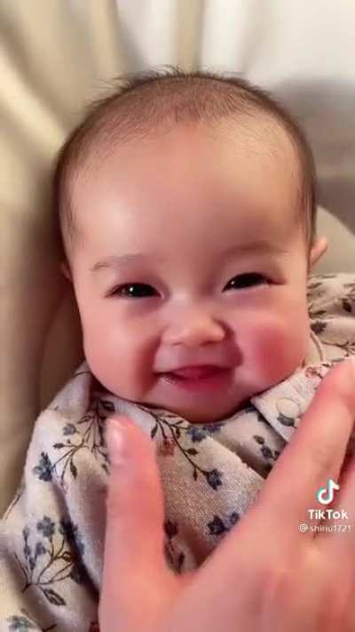 Look at This Cute Smile ? A Baby Enjoying Mom’s Touch