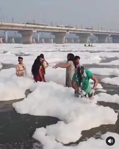 Indians bathe in the toxic foam-polluted Yamuna River in Delhi, India, October 2024.